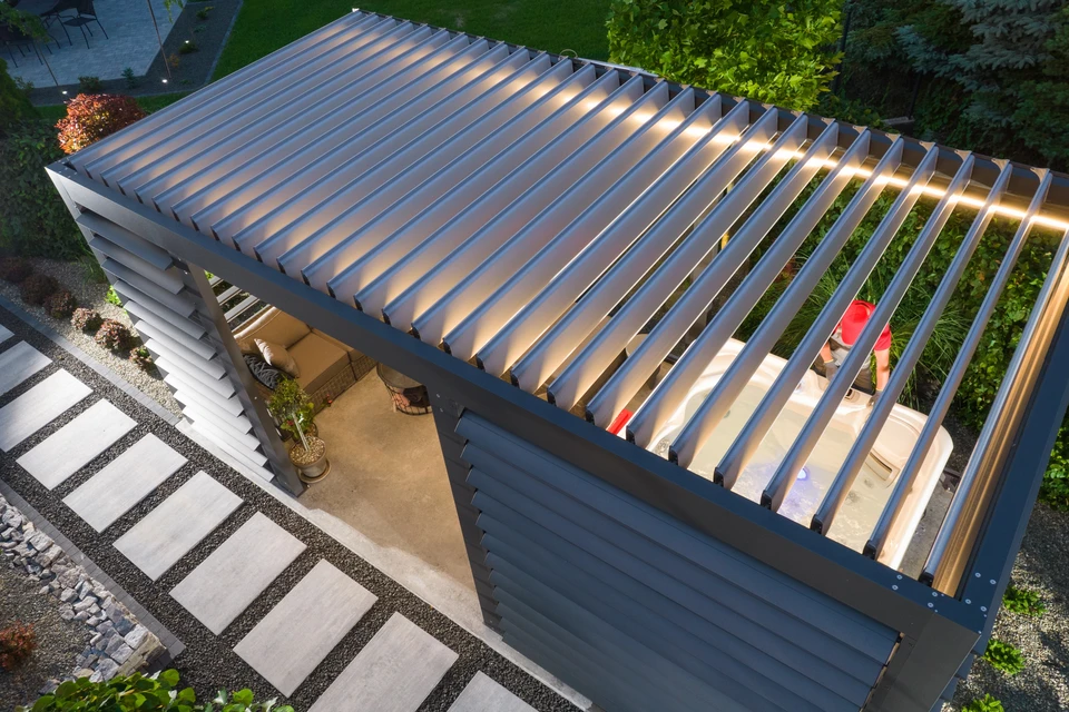 Carport double en acier anthracite avec toiture plate, intégrant un claustra en lames de bois massif horizontal sur les côtés